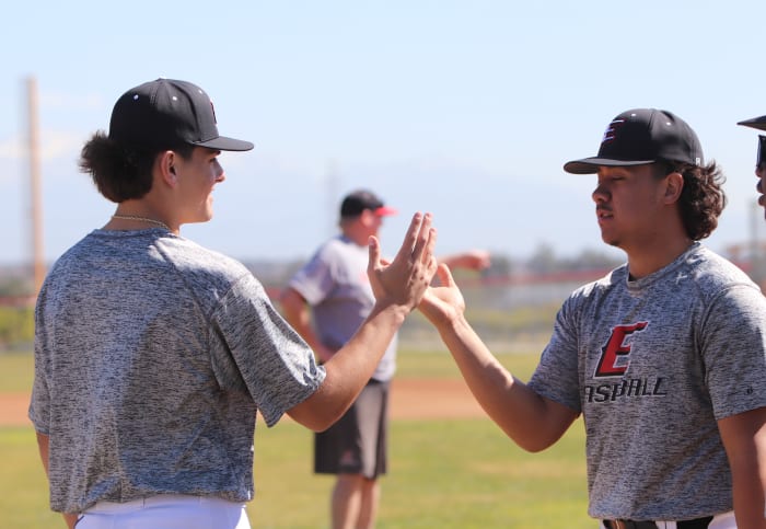 Brady shares a high five with a teammate.